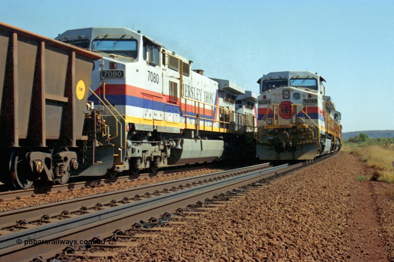 223-31
Possum Siding, a loaded train behind a pair of Hamersley Iron General Electric built Dash 9-44CW units 7072 serial 47751 and 7074 serial 47753 with the crew change completed, the empty is starting to roll on the passing track. 21st October 2000.
Keywords: 7072;GE;Dash-9-44CW;47751;