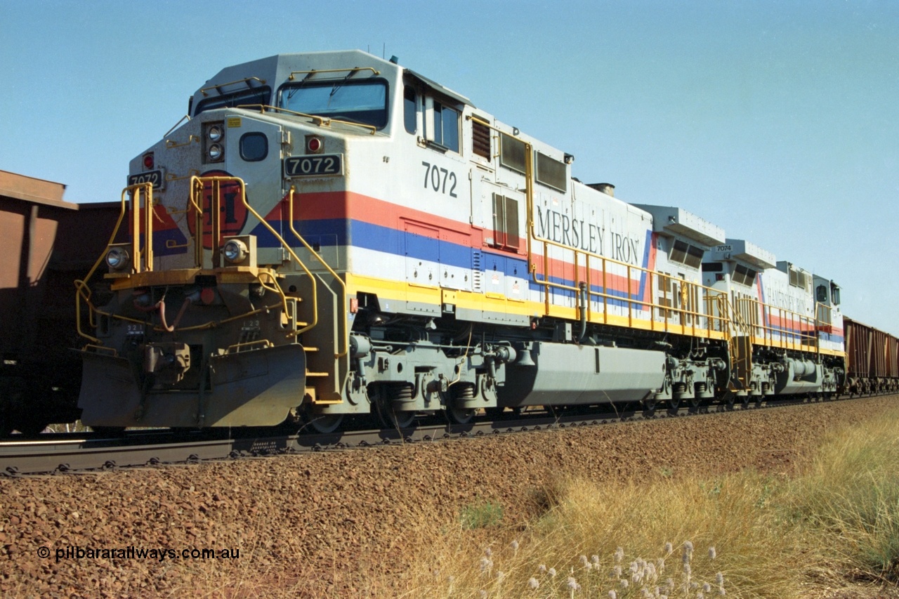 223-33
Possum Siding, a loaded train behind a pair of Hamersley Iron General Electric built Dash 9-44CW units 7072 serial 47751 and 7074 serial 47753 on a loaded train ex Marandoo with the crew change completed, the empty is rolling past on the passing track. 21st October 2000.
Keywords: 7072;GE;Dash-9-44CW;47751;