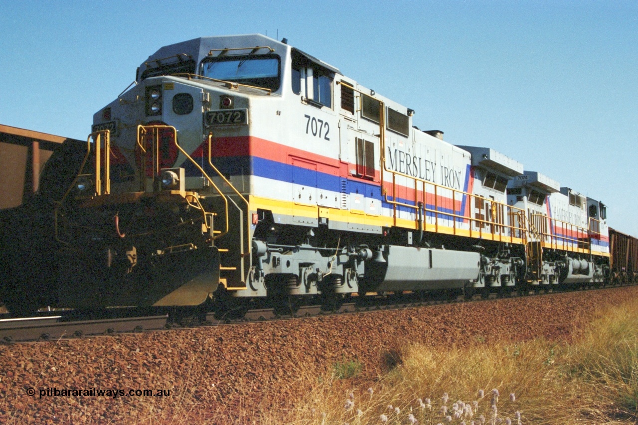 223-34
Possum Siding, a loaded train behind a pair of Hamersley Iron General Electric built Dash 9-44CW units 7072 serial 47751 and 7074 serial 47753 on a loaded train ex Marandoo with the crew change completed, the empty is rolling past on the passing track. 21st October 2000.
Keywords: 7072;GE;Dash-9-44CW;47751;