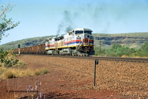 223-23
Possum Siding, Hamersley Iron loco 7082 a General Electric built Dash 9-44CW serial 47761 leads sister unit 7080 with an empty train as they power up to pull forward inside the loop to effect a crew change. 21st October 2000.
Keywords: 7082;GE;Dash-9-44CW;47761;