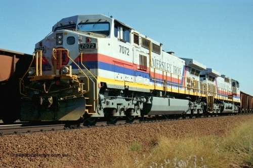 223-32
Possum Siding, a loaded train behind a pair of Hamersley Iron General Electric built Dash 9-44CW units 7072 serial 47751 and 7074 serial 47753 with the crew change completed, the empty is rolling past on the passing track. 21st October 2000.
Keywords: 7072;GE;Dash-9-44CW;47751;
