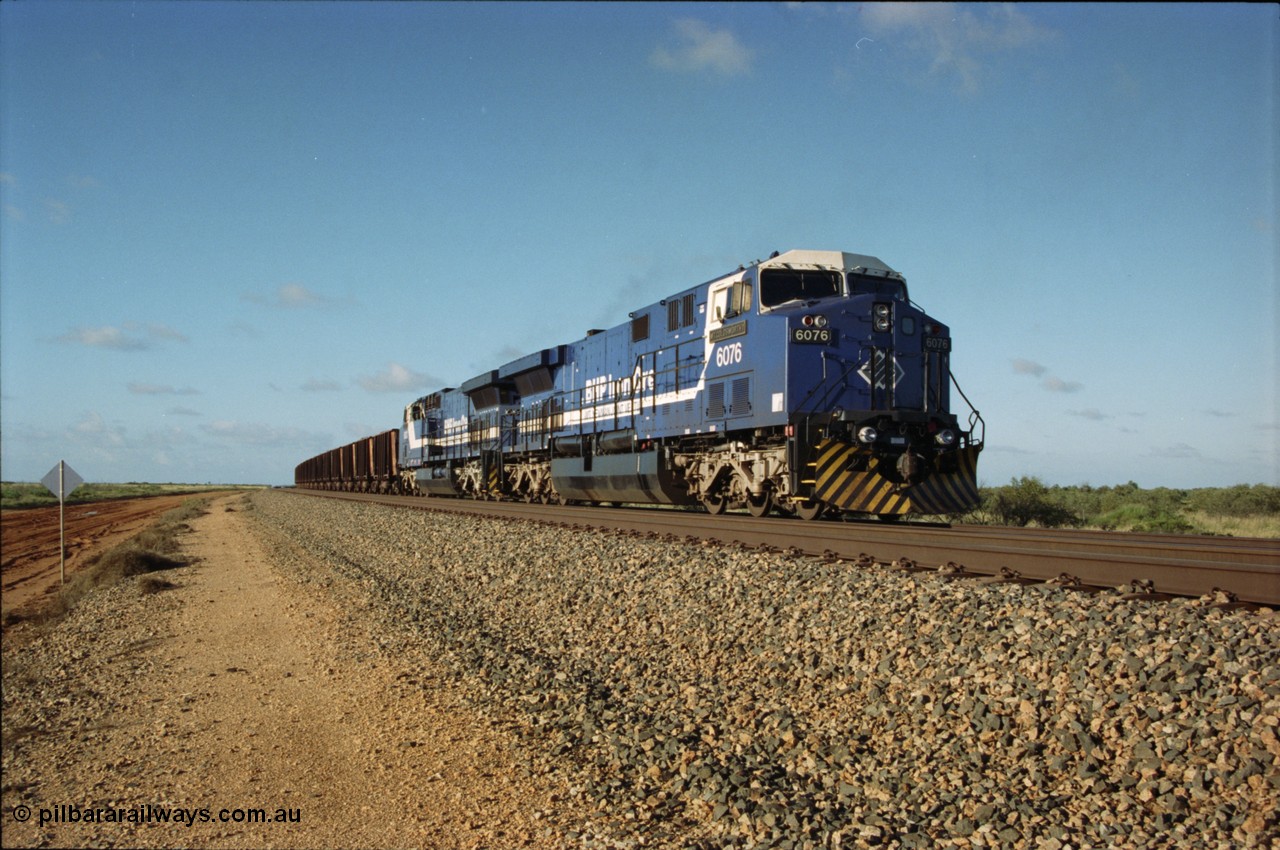 224-01
Bing siding, the afternoon empty to Yandi was a staple of the AC6000 units when delivered, operating the train as a pair, 112 waggons, AC6000 and 112 waggons. 6076 'Mt Goldsworthy' serial 51068 a General Electric AC6000 built by GE at Erie awaits the road to depart south with sister unit 6073. [url=https://goo.gl/maps/KQrczNpVhAH2]GeoData[/url].
Keywords: 6076;GE;AC6000;51068;