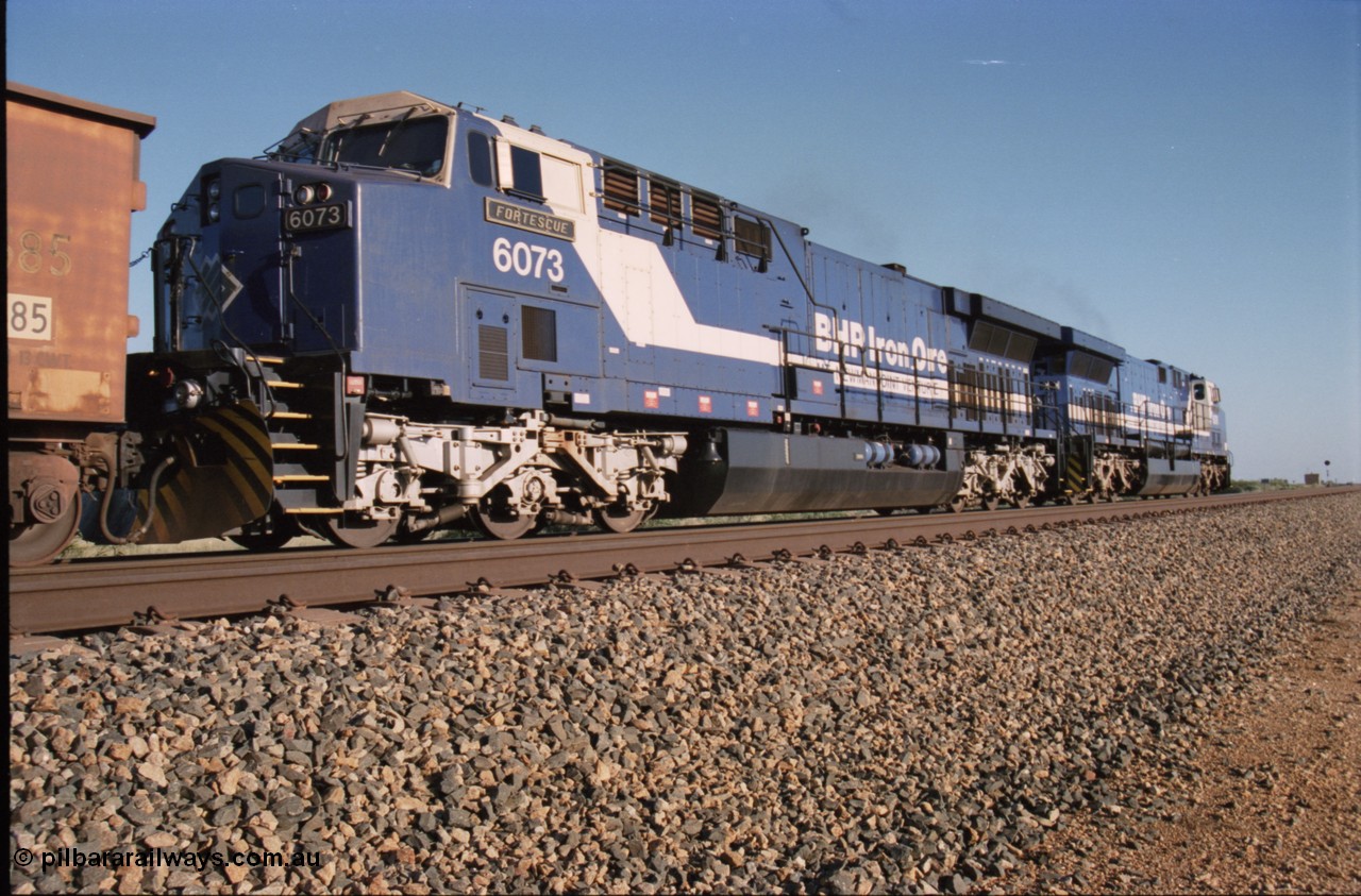 224-11
Bing siding, 6073 'Fortescue' serial 51065 a General Electric AC6000 built by GE at Erie awaits the road to depart south, shows new nameplate, steerable bogie and taper in cab side, second unit behind sister loco 6076. [url=https://goo.gl/maps/KQrczNpVhAH2]GeoData[/url].
Keywords: 6073;GE;AC6000;51065;