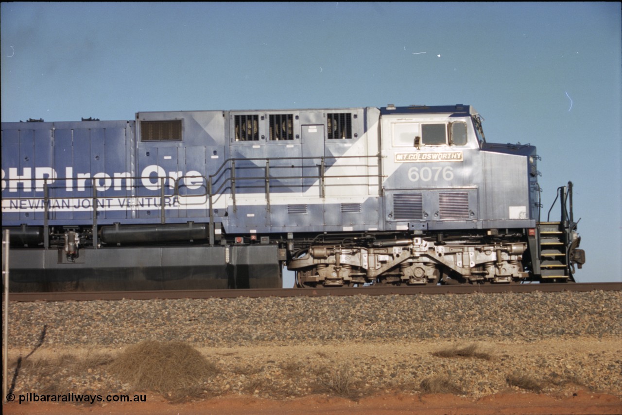 224-18
Bing siding, 6076 'Mt Goldsworthy' serial 51068 a General Electric AC6000 built by GE at Erie awaits the road to depart south, cab side shows new nameplate, steerable bogie and taper in cab side. [url=https://goo.gl/maps/KQrczNpVhAH2]GeoData[/url].
Keywords: 6076;GE;AC6000;51068;