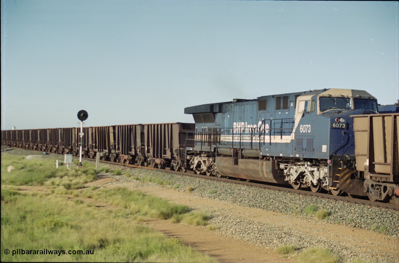 225-08
Bing siding, General Electric AC6000 model unit 6073 serial 51065 built at GE Erie is the mid-train remote for the afternoon empty Yandi mine train as it heads south. This was before the units were named. [url=https://goo.gl/maps/r3bVfZz8aJS2]GeoData[/url].
Keywords: 6073;GE;AC6000;51065;