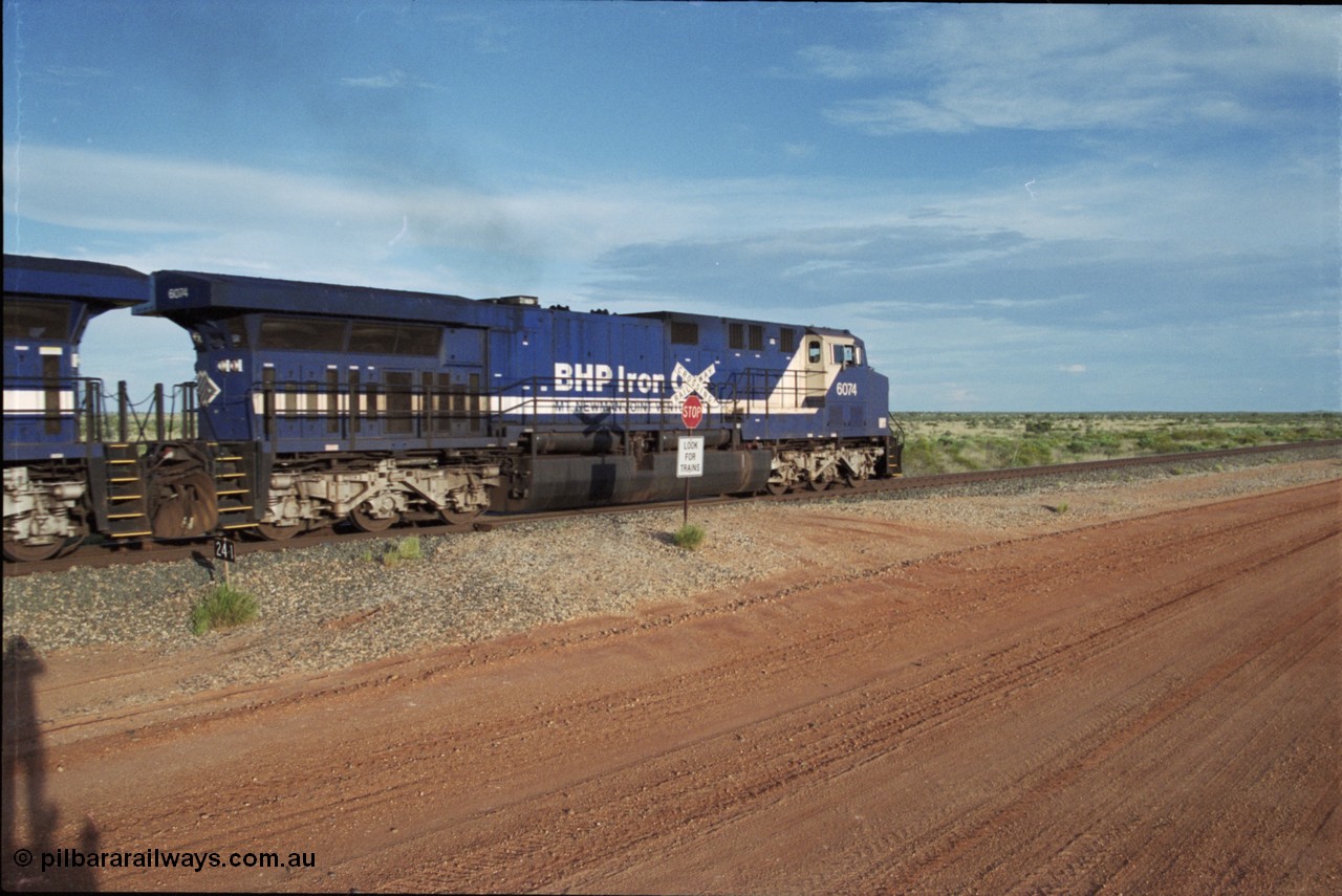 225-20
At the 24.1 km grade crossing on the BHP Newman line, General Electric AC6000 model unit 6074 serial 51066 built at GE Erie leads the afternoon empty Yandi mine train as it heads south. This was before the units were named. [url=https://goo.gl/maps/qGkyfiuy6212]GeoData[/url].
Keywords: 6074;GE;AC6000;51066;