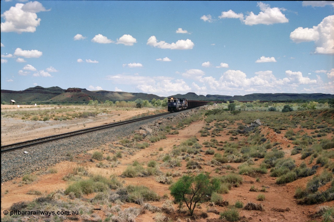 226-05
Redmont, at the 202 km, a loaded Yandi train descends the .76 percent grade with the standard of the time Double Dash 8 combination with 5653 and 5643 leading the charge. [url=https://goo.gl/maps/HYx9nXwpXfP2]GeoData[/url].
