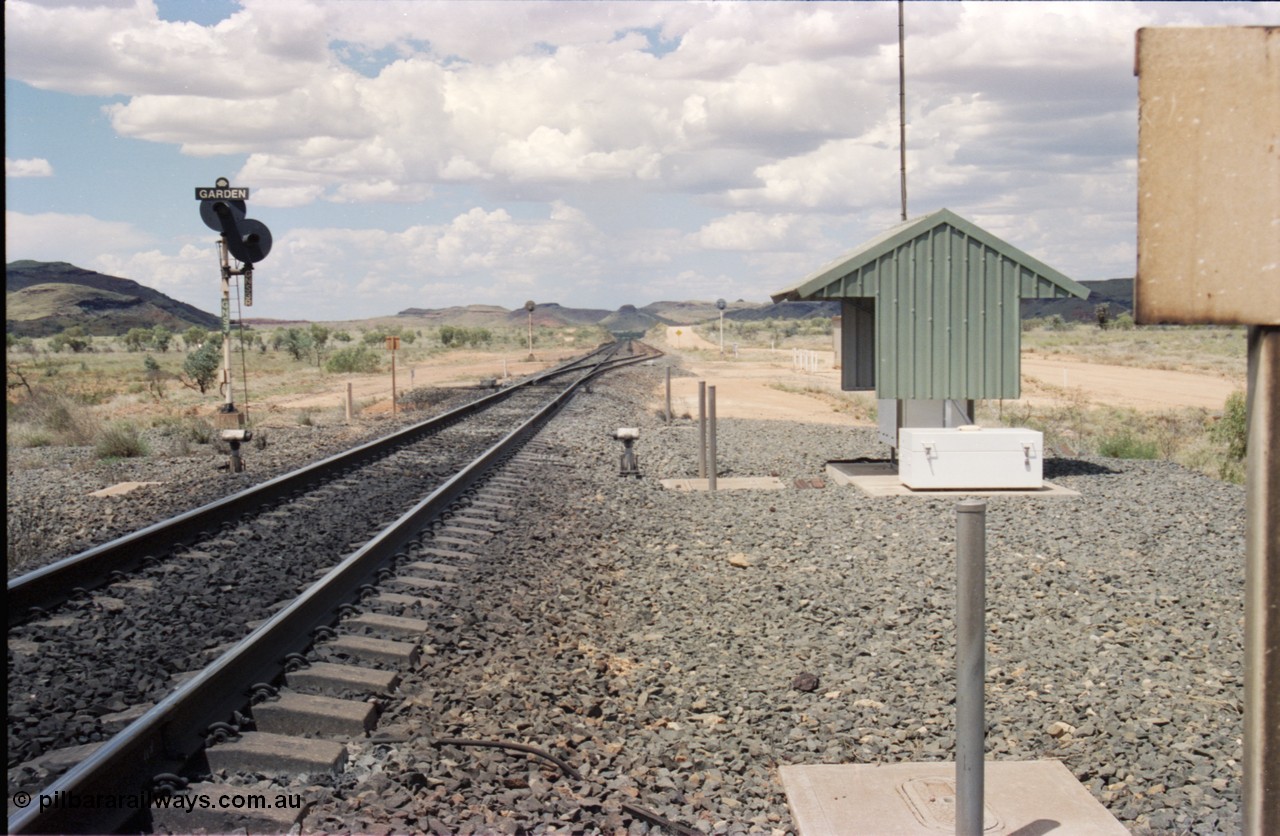 226-11
Garden Siding looking north from the south end. Signal post with dual heads, GNS 3 and GNS 3R which is a repeater signal aimed up the hill for loaded trains running down grade. The small units each side of the mainline is a Cold Wheel Detector. As the trains are running down a 5 km long 1.5 percent grade the trains are under dynamic and train brake control to maintain the train speed below the limit. [url=https://goo.gl/maps/GhqKW3xWJPq]GeoData[/url].
