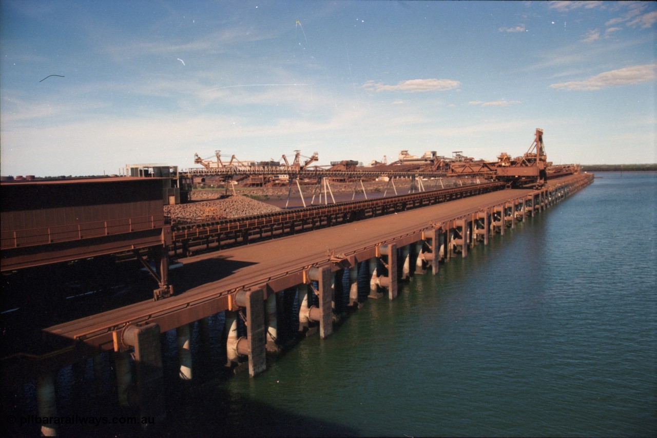 227-02
Nelson Point, view along A and B berths from Shiploader 2, Shiploader 1 on B berth, reclaimers 3 and 4 visible behind the under harbour tunnel feed conveyor. [url=https://goo.gl/maps/9YFk9Z8c7WG2]GeoData[/url].
