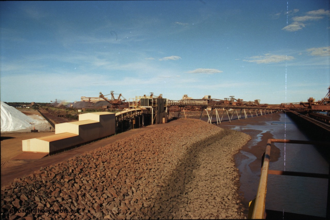 227-07
Nelson Point, view along the rear of A and B berths from Shiploader 2, salt pile on the left, then the under harbour tunnel portal, old reclaimers 3 and 4 with the crushing building in the distance, which has now been demolished, and the rear of Shiploader 1 on B berth. [url=https://goo.gl/maps/1sLxDMF5tZu]GeoData[/url].
