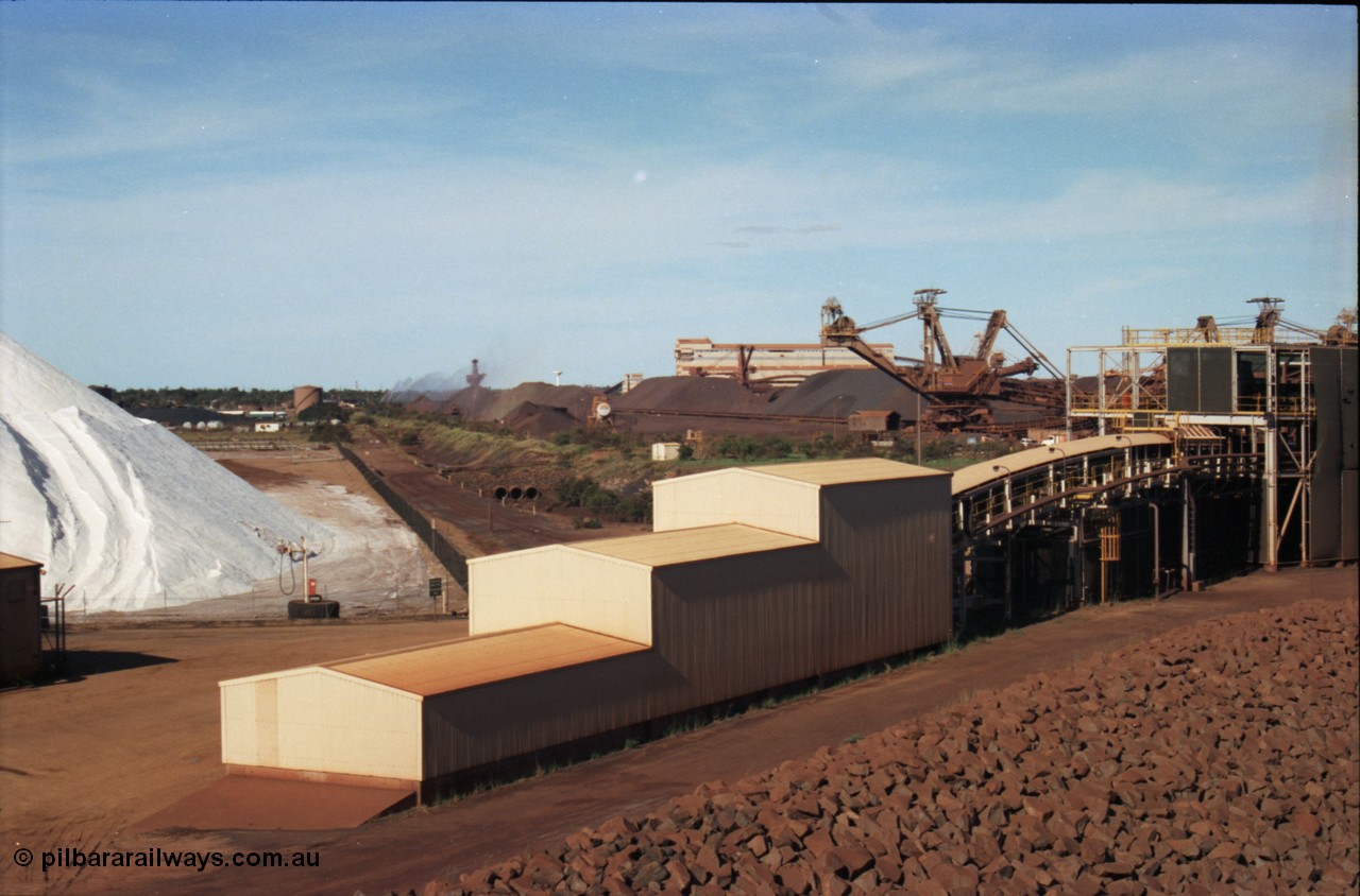 227-13
Nelson Point, view from rear of Shiploader 2, salt pile, manganese stockpile in the distance, stacker 3, the Port Hedland water tower, then 101-102 sample station and Tertiary Crushing Building One or TCB1, stacker 4 and reclaimer 3 with the under harbour portal in the foreground. [url=https://goo.gl/maps/1sLxDMF5tZu]GeoData[/url].
