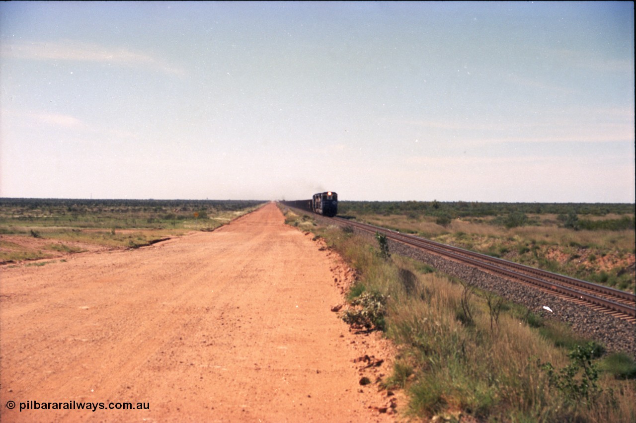 227-18
30 km area on the Newman mainline, east of the original Quarry 1, an empty train powers along the gentle .17% rising grade behind a pair of Goninan CM40-8M GE rebuild units and an General Electric AC6000. [url=https://goo.gl/maps/BY7Zz4F5t822]GeoData[/url].
