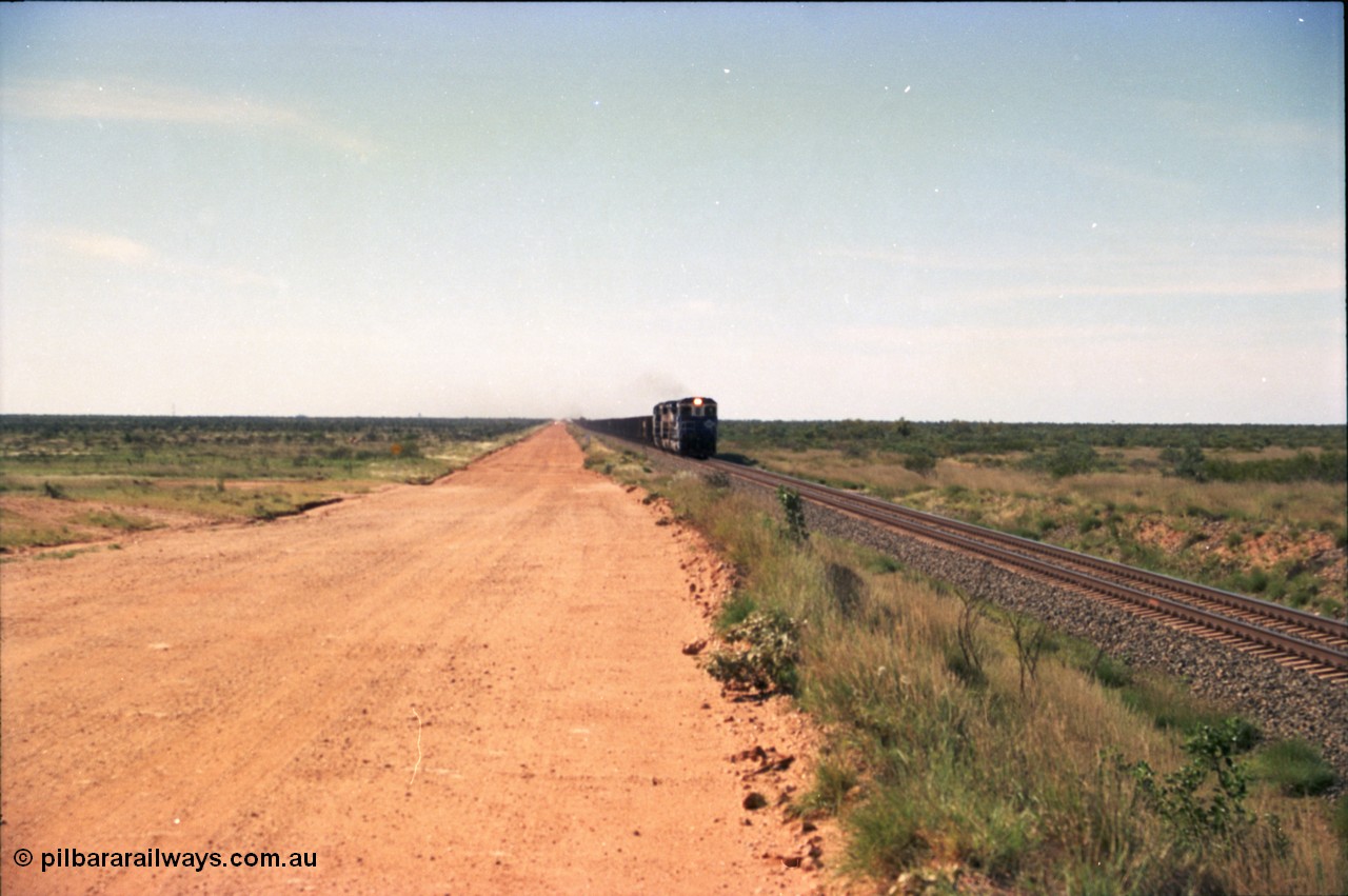 227-19
30 km area on the Newman mainline, east of the original Quarry 1, an empty train powers along the gentle .17% rising grade behind a pair of Goninan CM40-8M GE rebuild units and an General Electric AC6000. [url=https://goo.gl/maps/BY7Zz4F5t822]GeoData[/url].
