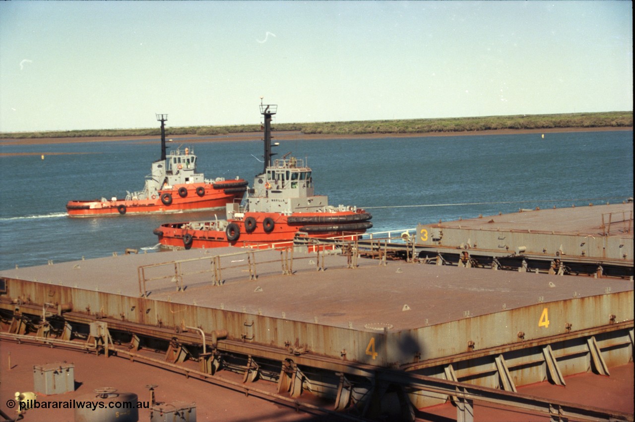 227-37
Nelson Point, tug boat Warilla, 50 ton bollard pull Z-Peller type, built by Tamar Steel Boats in Launceston in 1982, pulls a loaded carrier clear of B berth as a sister vessel Warang passes behind.
