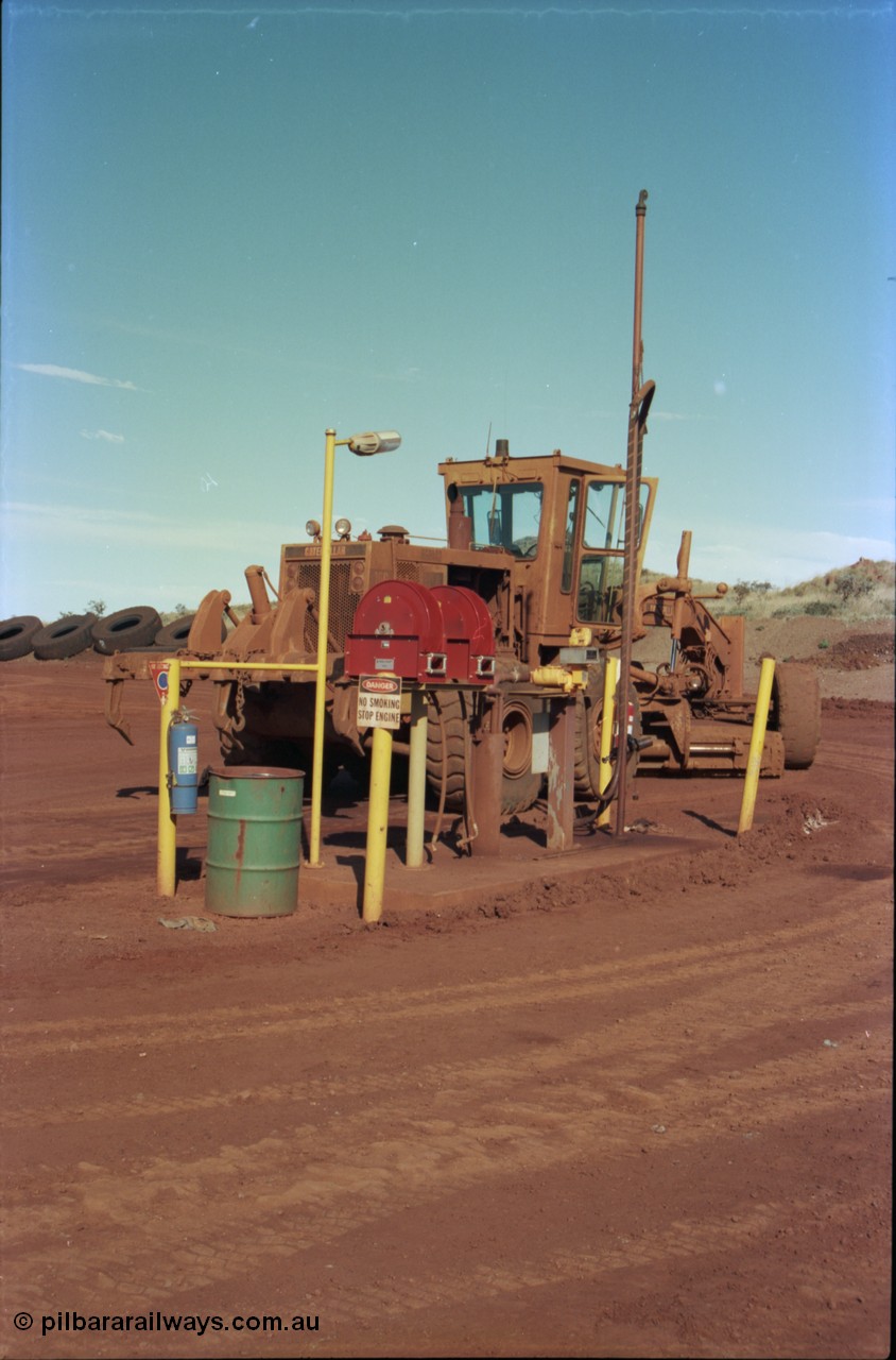 228-13
Yandi Two mobile machine fuel point. A Caterpillar 16G road motor grader is receiving attention.
Keywords: Caterpillar;16G;