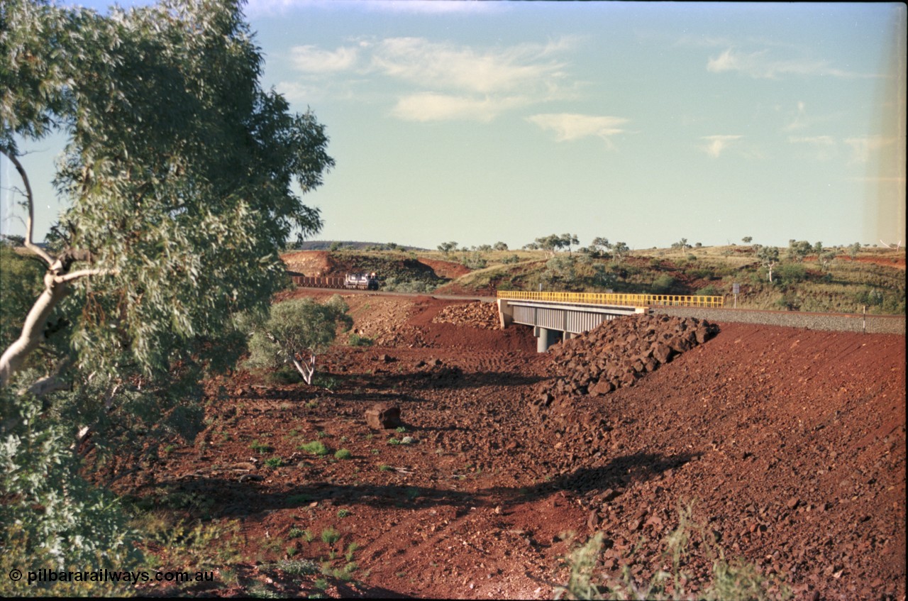 228-17
Yandi Two, the only real land mark on the Yandi Two branchline is this bridge over an un-named creek at the YT307 km with the afternoon empty train on approach. Geodata [url=https://goo.gl/maps/S1bX3ycGXqE2] -22.706976, 119.097651 [/url].
