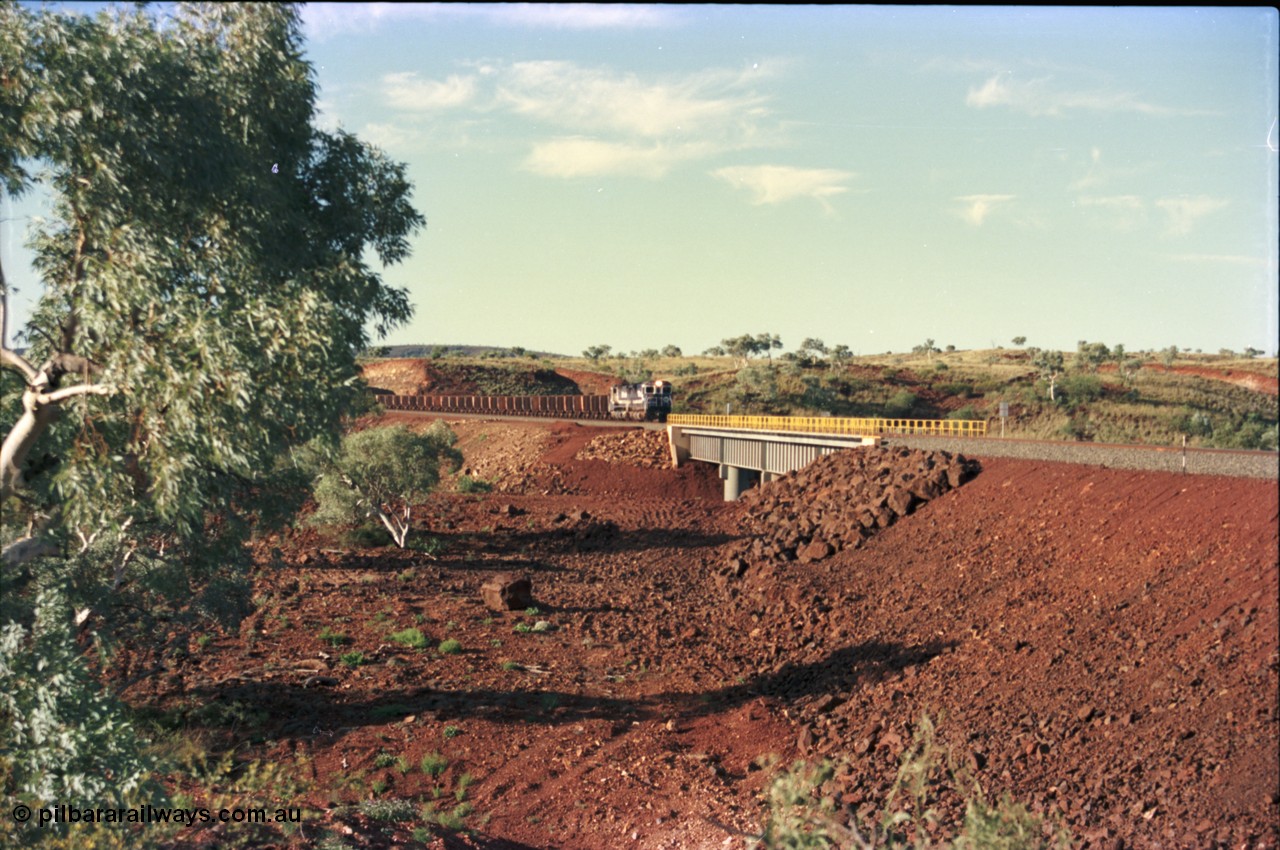 228-18
Yandi Two, the only real land mark on the Yandi Two branchline is this bridge over an un-named creek at the YT307 km with the afternoon empty train on approach. Geodata [url=https://goo.gl/maps/S1bX3ycGXqE2] -22.706976, 119.097651 [/url].
