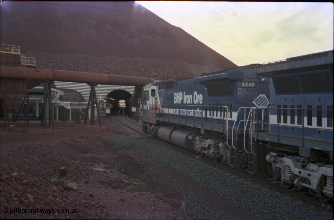 228-28
Yandi Two load-out tunnel, view of empty train about to enter for loading behind a standard pair of Goninan rebuilt GE CM40-8M model units 5649 'Pohang' serial 8412-07/93-140 and 5644 'Kangan' serial 8281-09/92-133. Geodata [url=https://goo.gl/maps/KbzBN9Bt4k52] -22.720824, 119.043410 [/url].
Keywords: 5649;Goninan;GE;CM40-8M;8412-07/93-140;rebuild;AE-Goodwin;ALCo;M636C;5473;G6047-5;