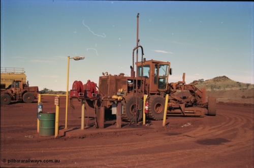 228-08
Yandi Two mobile machine fuel point. A Caterpillar 16G road motor grader is receiving attention.
Keywords: Caterpillar;16G;