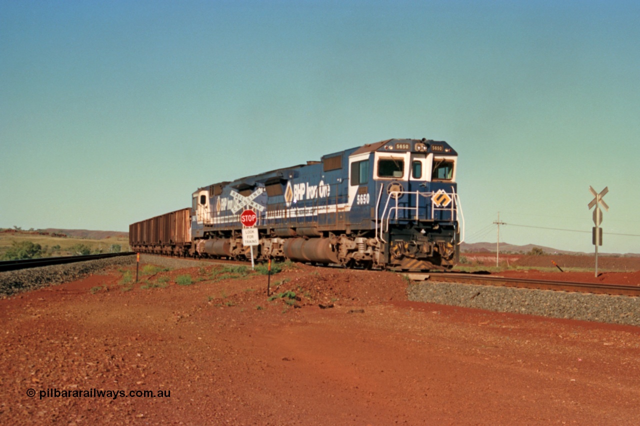 229-03
Yandi Two balloon switch looking east with an empty BHP train heading for the loadout behind a pair of Goninan rebuild CM40-8M GE units with 5650 'Yawata' serial 8412-07 / 93-141 leading sister unit 5642, grade crossing is the YT 311.5 km. [url=https://goo.gl/maps/DcycDGojcBt]GeoData[/url].
Keywords: 5650;Goninan;GE;CM40-8M;8412-07/93-141;rebuild;AE-Goodwin;ALCo;M636C;5481;G6061-2;