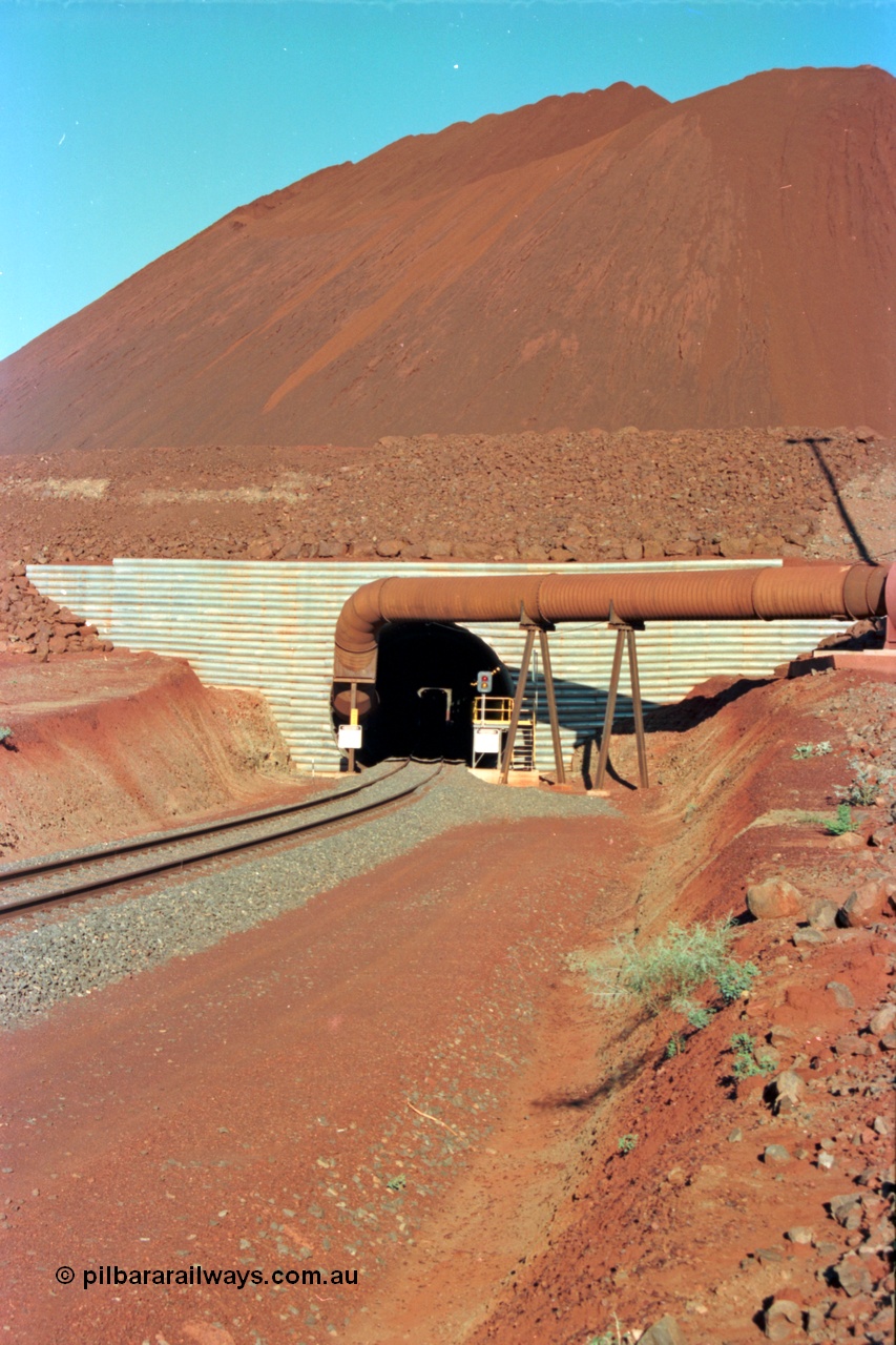 229-14
Yandi Two loadout, looking through the tunnel and the CM40-8M profile of 5650 can be just made out, the massive pile of ore is gravity fed into the waggons via two sets of hydraulic chutes, Yandi Two features to loadout vaults for extra capacity, in later years it allowed two different products, fines and lumps to be stacked. [url=https://goo.gl/maps/jmtnauf76Zq]GeoData[/url].
