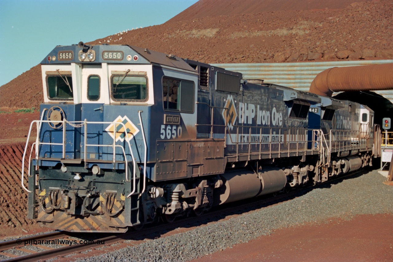 229-17
Yandi Two loadout, looking at the exit portal of the tunnel as Goninan rebuild CM40-8M GE unit 5650 'Yawata' serial 8412-07 / 93-141 and sister 5642 drag a loading train at 1.2 km/h, the red and amber lights control entry to the tunnel and the steel pipe is for dust extraction. [url=https://goo.gl/maps/jmtnauf76Zq]GeoData[/url].
Keywords: 5650;Goninan;GE;CM40-8M;8412-07/93-141;rebuild;AE-Goodwin;ALCo;M636C;5481;G6061-2;