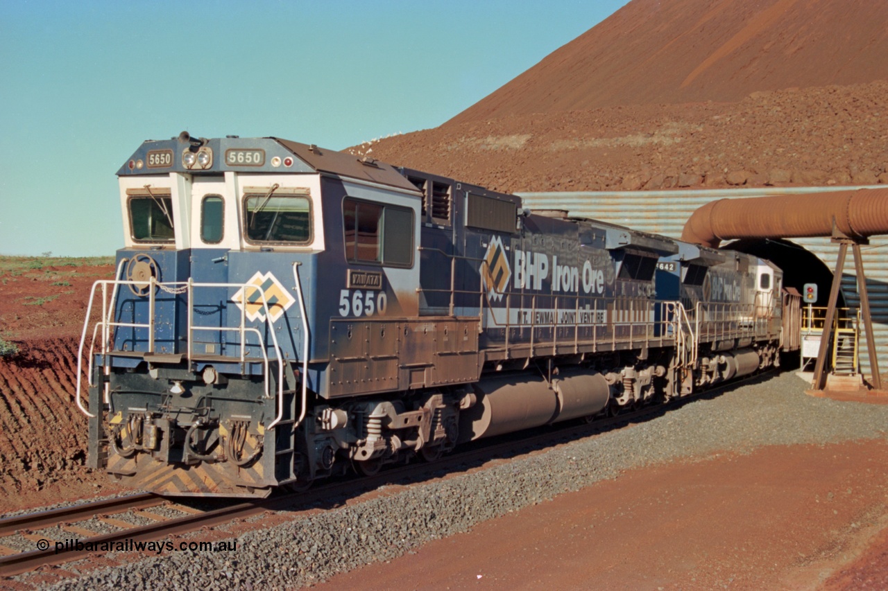 229-18
Yandi Two loadout, looking at the exit portal of the tunnel as Goninan rebuild CM40-8M GE unit 5650 'Yawata' serial 8412-07 / 93-141 and sister 5642 drag a loading train at 1.2 km/h, the red and amber lights control entry to the tunnel and the steel pipe is for dust extraction. [url=https://goo.gl/maps/jmtnauf76Zq]GeoData[/url].
Keywords: 5650;Goninan;GE;CM40-8M;8412-07/93-141;rebuild;AE-Goodwin;ALCo;M636C;5481;G6061-2;