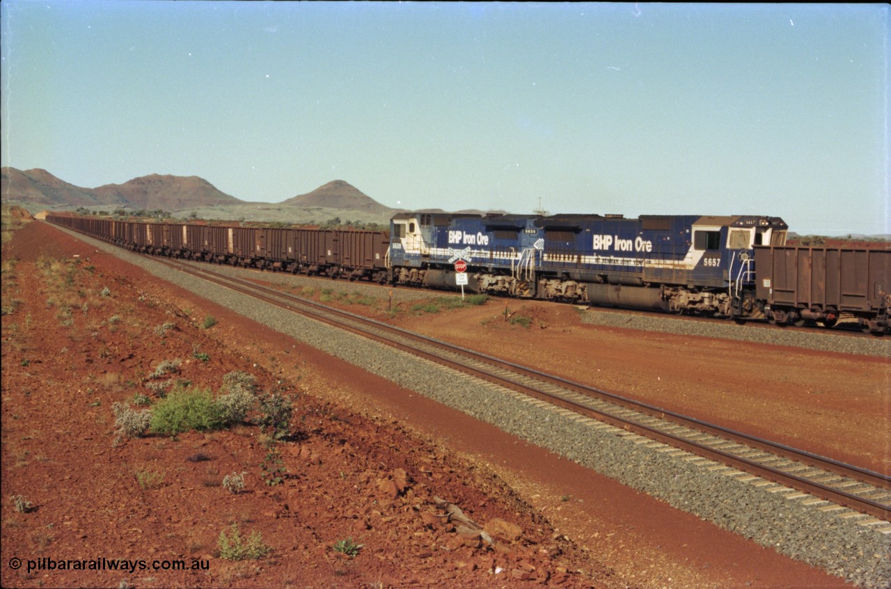 230-10
Yandi Two balloon loop, empty car line, mid-train remote units side view, two Goninan GE CM40-8M rebuilds from different ALCo builders. 5657 'Fukuyama' serial 8412-02/94-148 is from Comeng ALCo M636 unit 5492 while 5639 'Corunna Downs' serial 8281-03/92-128 is from an AE Goodwin ALCo C636 unit 5459. Geodata [url=https://goo.gl/maps/DcycDGojcBt] -22.713725, 119.055762 [/url].
Keywords: 5657;Goninan;GE;CM40-8M;8412-02/94-148;rebuild;Comeng-NSW;ALCo;M636C;5492;C6084-8;