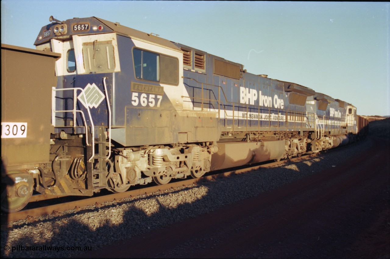 230-34
Yandi Two balloon loop, mid-train remote units Goninan GE CM40-8M rebuilds from different ALCo builders. 5657 'Fukuyama' serial 8412-02/94-148 is from Comeng ALCo M636 unit 5492 while 5639 'Corunna Downs' serial 8281-03/92-128 is from an AE Goodwin ALCo C636 unit 5459. Note the marker lights on 5657 and the sheet metal windscreen protectors to prevent the blown ore pitting the screens. Geodata [url=https://goo.gl/maps/h68ia1caJvL2] -22.718338, 119.039909 [/url].
Keywords: 5654;Goninan;GE;CM40-8M;8412-11/93-145;rebuild;Comeng-NSW;ALCo;M636C;5493;C6084-9;