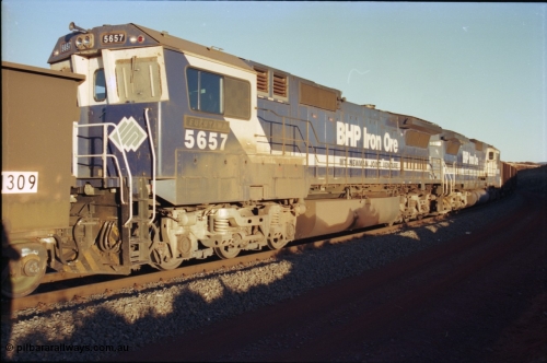 230-34
Yandi Two balloon loop, mid-train remote units Goninan GE CM40-8M rebuilds from different ALCo builders. 5657 'Fukuyama' serial 8412-02/94-148 is from Comeng ALCo M636 unit 5492 while 5639 'Corunna Downs' serial 8281-03/92-128 is from an AE Goodwin ALCo C636 unit 5459. Note the marker lights on 5657 and the sheet metal windscreen protectors to prevent the blown ore pitting the screens. Geodata [url=https://goo.gl/maps/h68ia1caJvL2] -22.718338, 119.039909 [/url].
Keywords: 5654;Goninan;GE;CM40-8M;8412-11/93-145;rebuild;Comeng-NSW;ALCo;M636C;5493;C6084-9;