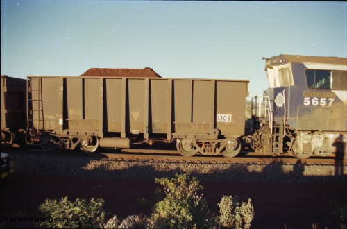 230-36
Yandi Two balloon loop, Comeng built ore car 1309 one of 226 cars ordered in 1973, note the ladder. Loaded with Yandi Fines ore. Geodata [url=https://goo.gl/maps/h68ia1caJvL2] -22.718338, 119.039909 [/url].
Keywords: 1309;Comeng-WA;BHP-ore-waggon;