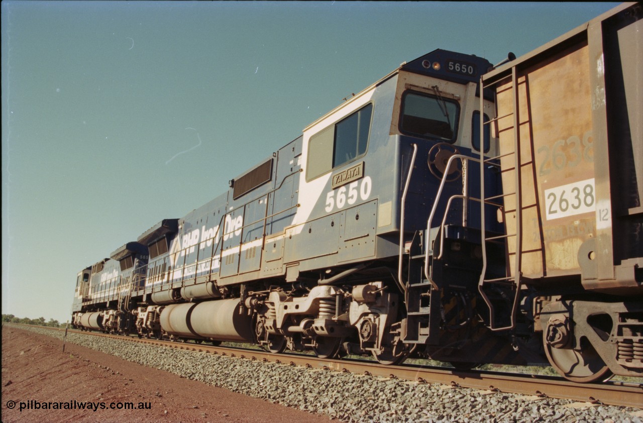 231-16
Yandi Two balloon loop, BHP Iron Ore 5650 'Yawata' serial 8412-09 / 93-141 an Goninan WA rebuild CM40-8M GE unit loads a train at 1.2 km/h as second unit, note the logos are the original teal and marigold and the round style fuel tanks tells us this units was rebuilt from an AE Goodwin built M636 ALCo. [url=https://goo.gl/maps/3vQHZqBXNa32]GeoData[/url].
Keywords: 5650;Goninan;GE;CM40-8M;8412-07/93-141;rebuild;AE-Goodwin;ALCo;M636C;5481;G6061-2;