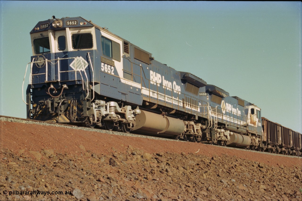 231-19
Yandi Two balloon loop, BHP Iron Ore 5652 'Villanueva' serial 8412-09 / 93-143 an Goninan WA rebuild CM40-8M GE unit loads a train at 1.2 km/h with second unit 5650. [url=https://goo.gl/maps/3vQHZqBXNa32]GeoData[/url].
Keywords: 5652;Goninan;GE;CM40-8M;8412-09/93-143;rebuild;AE-Goodwin;ALCo;M636C;5482;G6061-3;