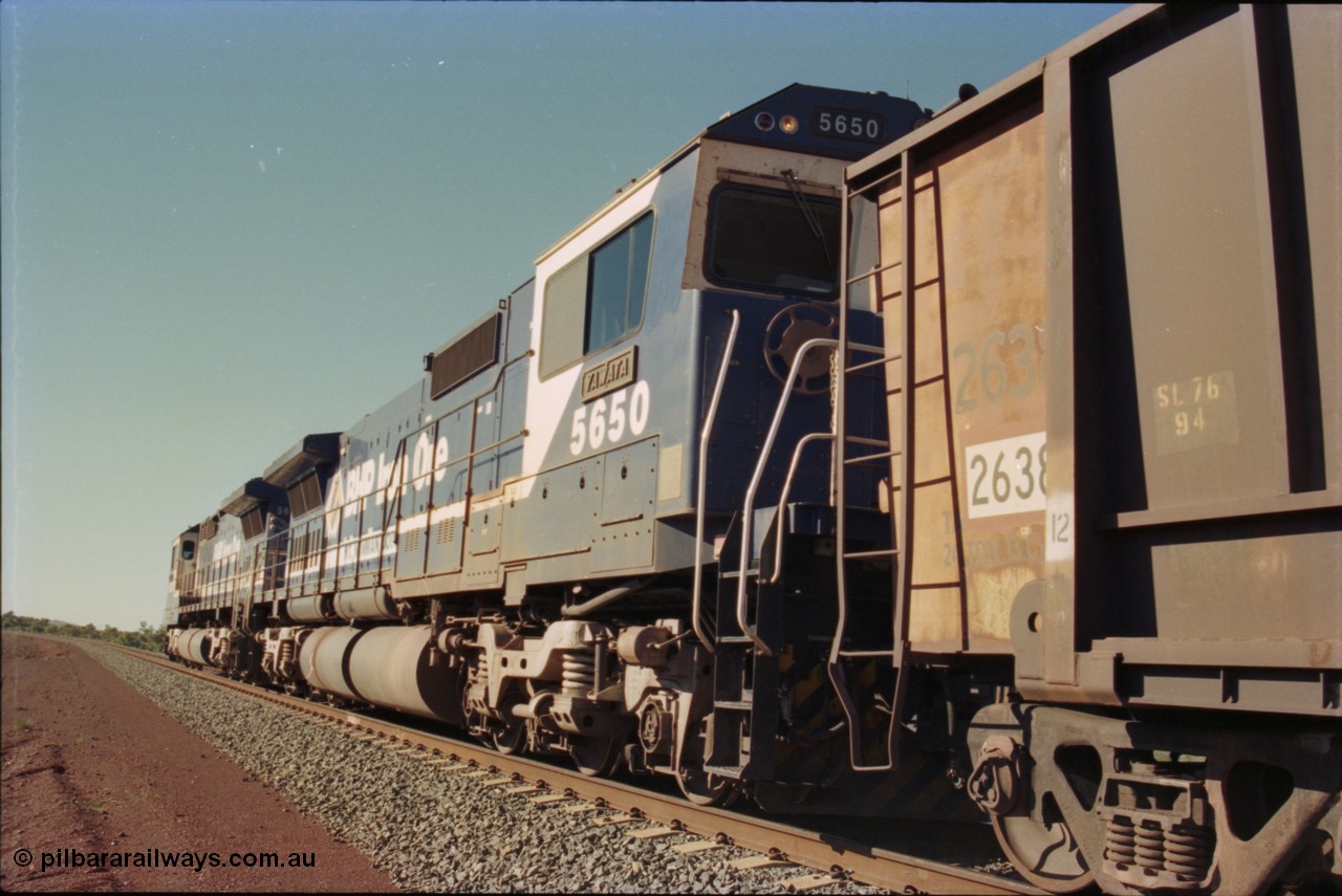 231-23
Yandi Two balloon loop, BHP Iron Ore 5650 'Yawata' serial 8412-09 / 93-141 an Goninan WA rebuild CM40-8M GE unit loads a train at 1.2 km/h as second unit, note the logos are the original teal and marigold and the round style fuel tanks tells us this units was rebuilt from an AE Goodwin built M636 ALCo. [url=https://goo.gl/maps/3vQHZqBXNa32]GeoData[/url].
Keywords: 5650;Goninan;GE;CM40-8M;8412-07/93-141;rebuild;AE-Goodwin;ALCo;M636C;5481;G6061-2;