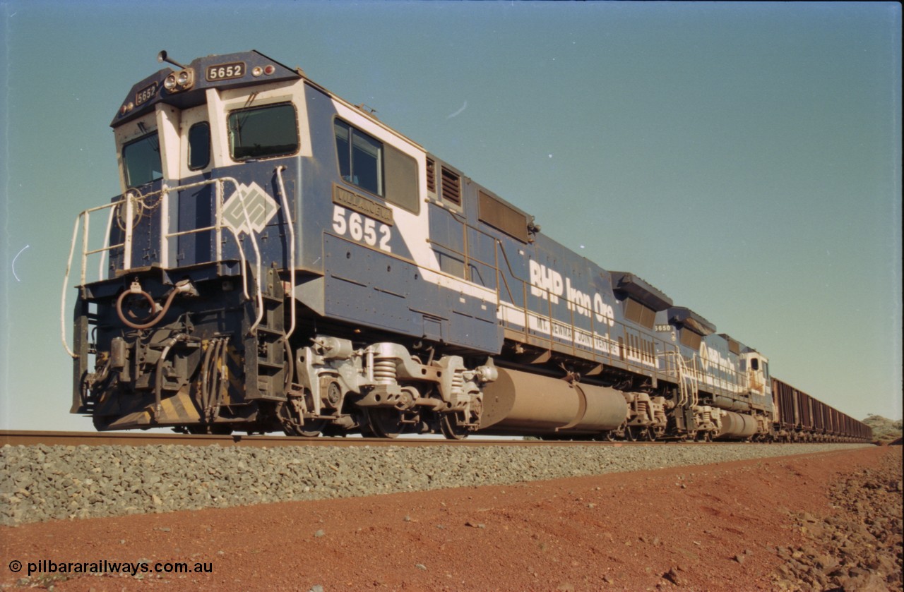 231-27
Yandi Two balloon loop, BHP Iron Ore 5652 'Villanueva' serial 8412-09 / 93-143 an Goninan WA rebuild CM40-8M GE unit loads a train at 1.2 km/h with second unit 5650. [url=https://goo.gl/maps/3vQHZqBXNa32]GeoData[/url].
Keywords: 5652;Goninan;GE;CM40-8M;8412-09/93-143;rebuild;AE-Goodwin;ALCo;M636C;5482;G6061-3;