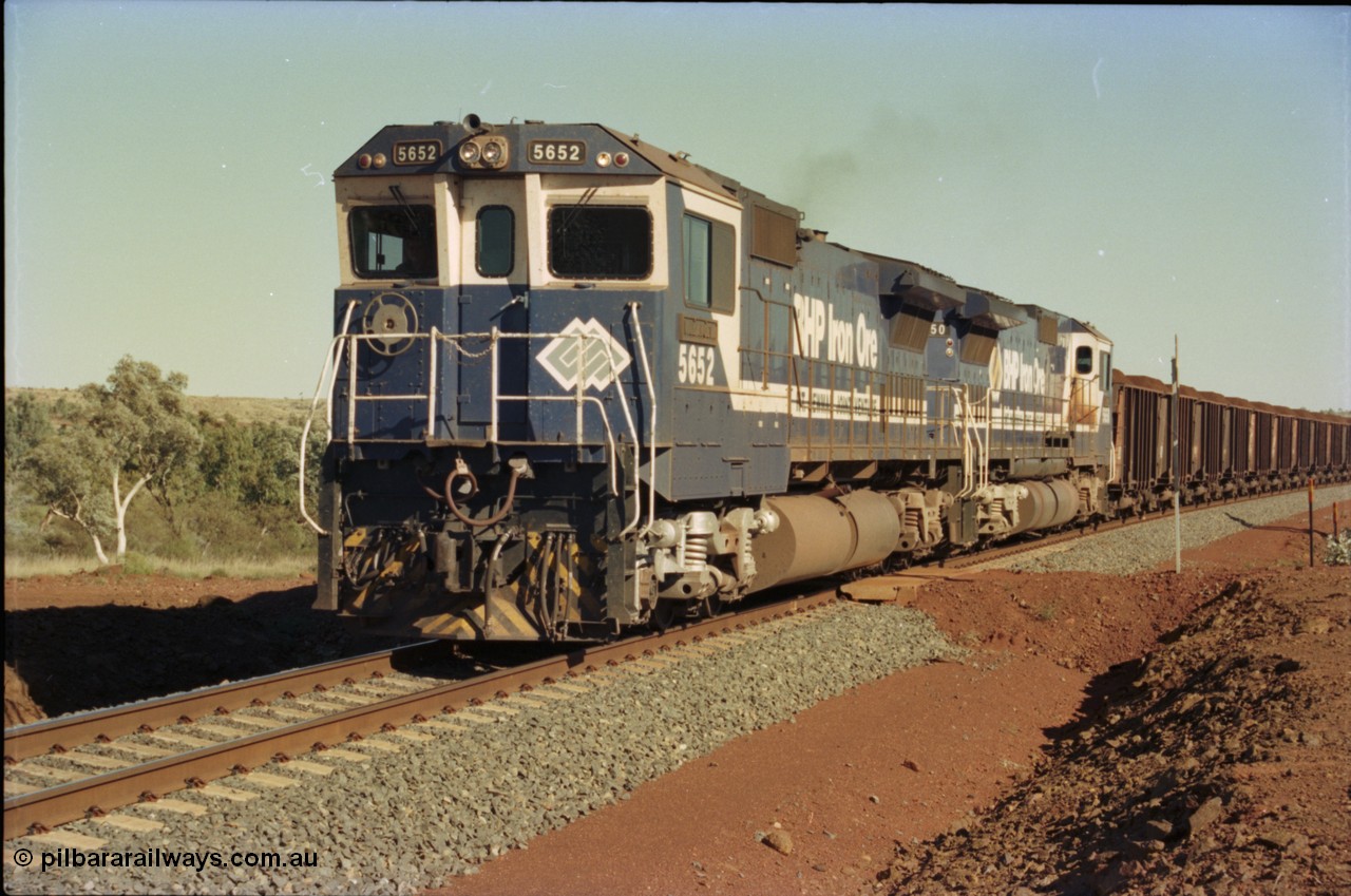 231-35
Yandi Two balloon loop 316.2 km grade crossing, BHP Iron Ore 5652 'Villanueva' serial 8412-09 / 93-143 an Goninan WA rebuild CM40-8M GE unit loads a train at 1.2 km/h with second unit 5650. [url=https://goo.gl/maps/N6VUeKeBS682]GeoData[/url].
Keywords: 5652;Goninan;GE;CM40-8M;8412-09/93-143;rebuild;AE-Goodwin;ALCo;M636C;5482;G6061-3;