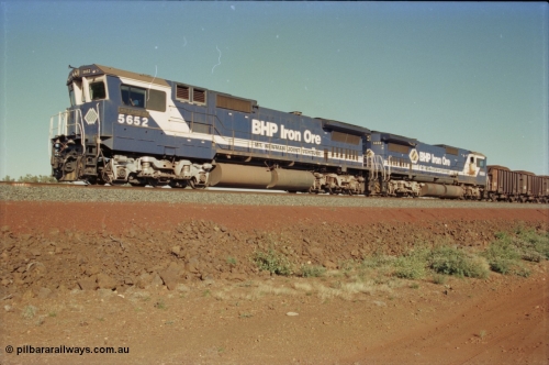 231-04
Yandi Two balloon loop, BHP Iron Ore 5652 'Villanueva' serial 8412-09 / 93-143 an Goninan WA rebuild CM40-8M GE unit loads a train at 1.2 km/h with second unit 5650 'Yawata' serial 8412-07 / 93-141, note the difference in the liveries, 50 is in the teal and marigold logo and logo on the hood while 52 has the silver logo on the front only and no logo on the hood. [url=https://goo.gl/maps/3vQHZqBXNa32]GeoData[/url].
Keywords: 5652;Goninan;GE;CM40-8M;8412-09/93-143;rebuild;AE-Goodwin;ALCo;M636C;5482;G6061-3;