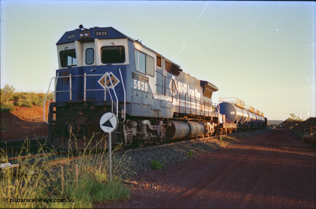 232-10
Yandi One backtrack, following a cyclone shutdown of the mainline and severe flooding around Yandi a 'mixed' freight train was operated to Yandi to deliver food, mail and diesel fuel to the mine and camp. Here BHP Iron Ore CM40-8M unit 5639 'Corunna Downs' serial 8281-03 / 92-128 idles away in the backtrack awaiting its path back to Port Hedland with flat waggon 6703, four fuel tank waggons and a broken ore waggon. February 1997. [url=https://goo.gl/maps/6c1WFqjYSg42]GeoData[/url].
Keywords: 5639;Goninan;GE;CM40-8M;8281-03/92-128;rebuild;AE-Goodwin;ALCo;C636;5459;G6027-3;