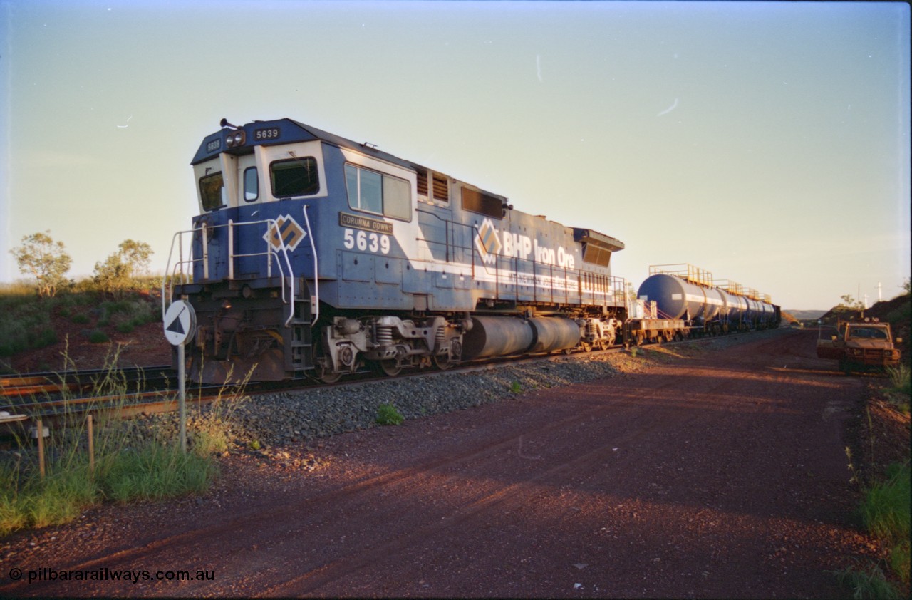 232-11
Yandi One backtrack, following a cyclone shutdown of the mainline and severe flooding around Yandi a 'mixed' freight train was operated to Yandi to deliver food, mail and diesel fuel to the mine and camp. Here BHP Iron Ore CM40-8M unit 5639 'Corunna Downs' serial 8281-03 / 92-128 idles away in the backtrack awaiting its path back to Port Hedland with flat waggon 6703, four fuel tank waggons and a broken ore waggon. February 1997. [url=https://goo.gl/maps/6c1WFqjYSg42]GeoData[/url].
Keywords: 5639;Goninan;GE;CM40-8M;8281-03/92-128;rebuild;AE-Goodwin;ALCo;C636;5459;G6027-3;