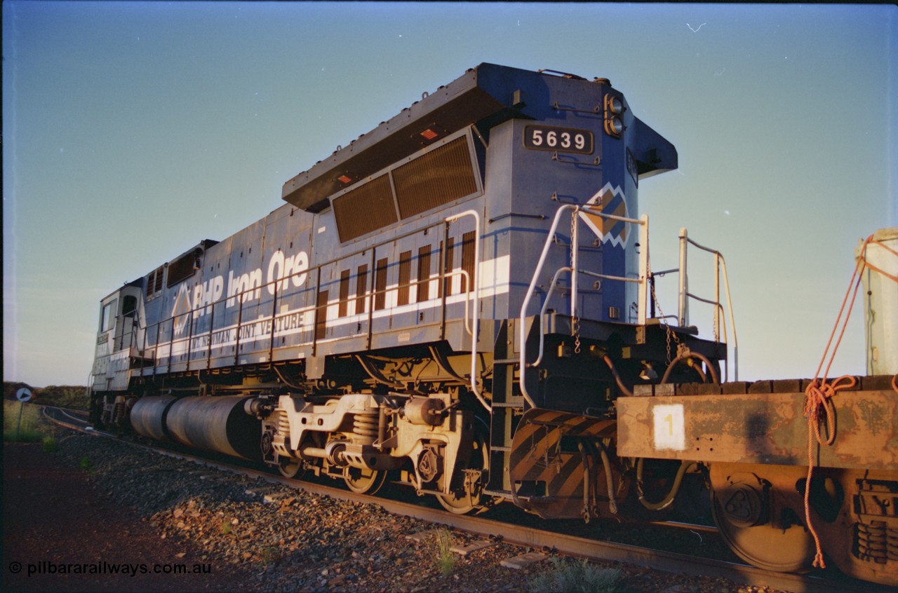 232-14
Yandi One backtrack, following a cyclone shutdown of the mainline and severe flooding around Yandi a 'mixed' freight train was operated to Yandi to deliver food, mail and diesel fuel to the mine and camp. Here BHP Iron Ore CM40-8M unit 5639 'Corunna Downs' serial 8281-03 / 92-128 idles away in the backtrack awaiting its path back to Port Hedland with flat waggon 6703, four fuel tank waggons and a broken ore waggon. February 1997. [url=https://goo.gl/maps/6c1WFqjYSg42]GeoData[/url].
Keywords: 5639;Goninan;GE;CM40-8M;8281-03/92-128;rebuild;AE-Goodwin;ALCo;C636;5459;G6027-3;