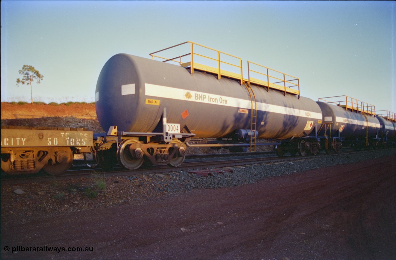 232-15
Yandi One backtrack, following a cyclone shutdown of the mainline and severe flooding around Yandi a 'mixed' freight train was operated to Yandi to deliver food, mail and diesel fuel to the mine and camp. Here BHP Iron Ore empty 82 kL Comeng NSW built tank waggon 0004 one of six such tank waggons built in 1970-71. February 1997. [url=https://goo.gl/maps/6c1WFqjYSg42]GeoData[/url].
Keywords: 0004;Comeng-NSW;BHP-tank-waggon;