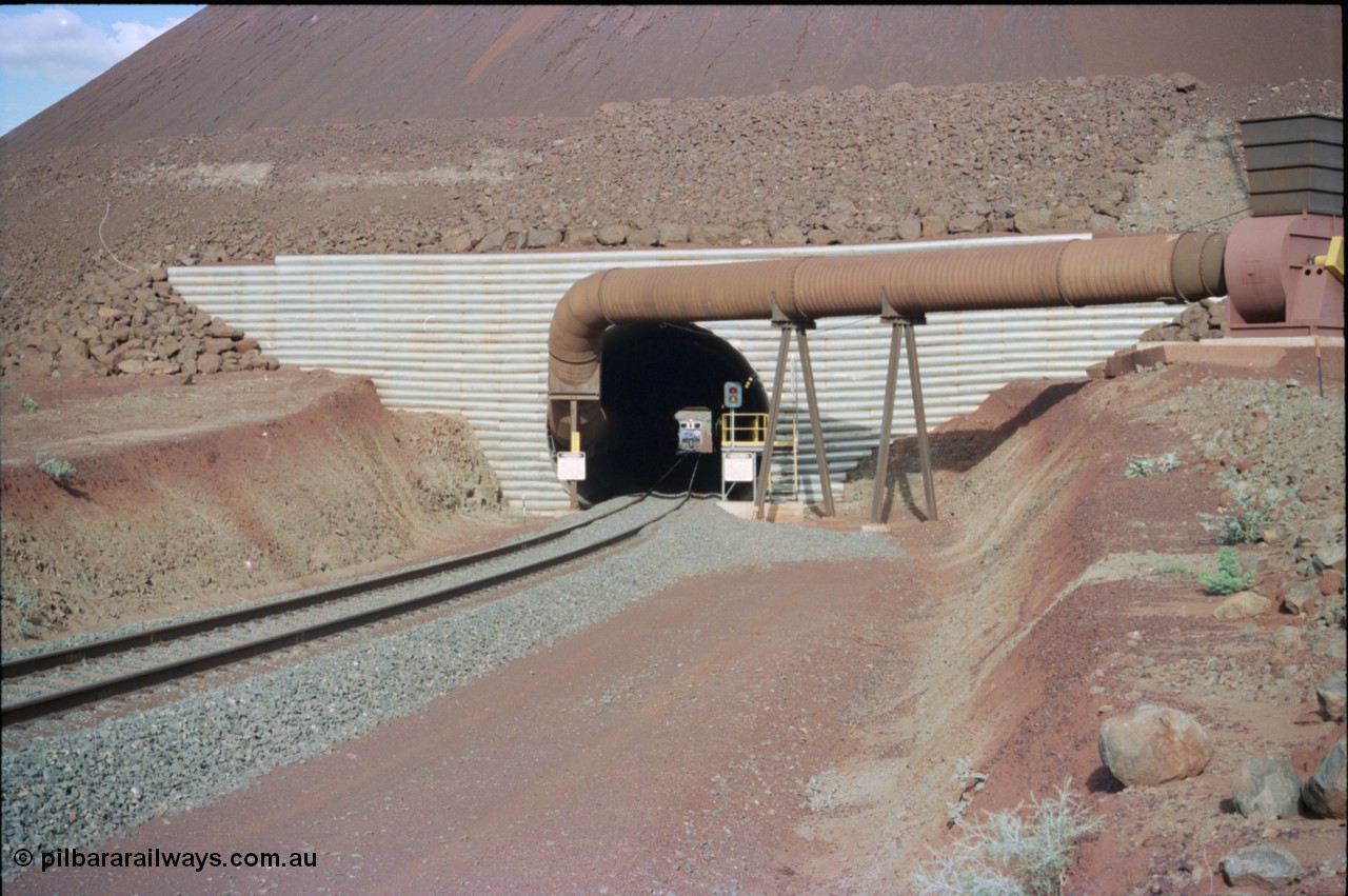 233-03
Yandi Two exit portal or loaded car side of load-out tunnel, the Yandi Two load-out has two load-out stations or vaults to allow to different products to be loaded. Only one vault is used at a time. An empty train can be seen about to enter the tunnel. [url=https://goo.gl/maps/RgJfYGtPXb52]GeoData[/url].
