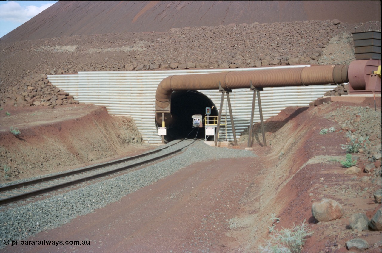 233-04
Yandi Two exit portal or loaded car side of load-out tunnel, the Yandi Two load-out has two load-out stations or vaults to allow to different products to be loaded. Only one vault is used at a time. An empty train can be seen about to enter the tunnel. [url=https://goo.gl/maps/RgJfYGtPXb52]GeoData[/url].
