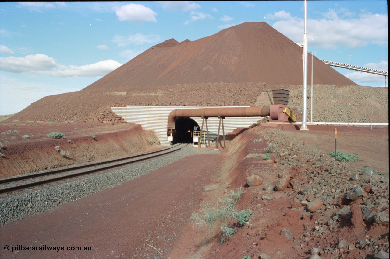 233-05
Yandi Two exit portal or loaded car side of load-out tunnel, the Yandi Two load-out has two load-out stations or vaults to allow to different products to be loaded. Only one vault is used at a time. An empty trains headlight can be seen in the tunnel. [url=https://goo.gl/maps/RgJfYGtPXb52]GeoData[/url].
