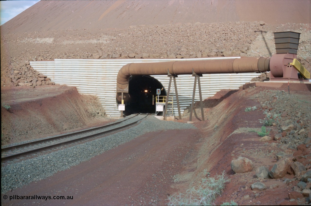 233-06
Yandi Two exit portal or loaded car side of load-out tunnel, the Yandi Two load-out has two load-out stations or vaults to allow to different products to be loaded. Only one vault is used at a time. An empty trains headlight can be seen in the tunnel. [url=https://goo.gl/maps/RgJfYGtPXb52]GeoData[/url].
