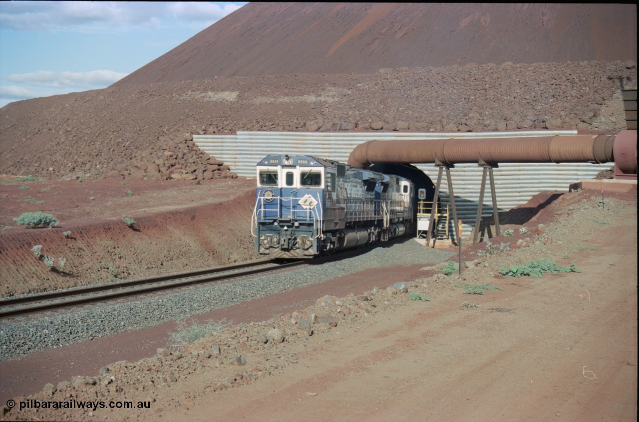 233-13
Yandi Two exit portal or loaded car side of load-out tunnel, the Yandi Two load-out has two load-out stations or vaults to allow to different products to be loaded. Only one vault is used at a time. A loading train lead by BHP Iron Ore's Goninan rebuild CM40-8M GE unit 5650 'Yawata' serial 8412-07 / 93-141 as it drags the train through at 1.2 km/h. [url=https://goo.gl/maps/RgJfYGtPXb52]GeoData[/url].
Keywords: 5650;Goninan;GE;CM40-8M;8412-07/93-141;rebuild;AE-Goodwin;ALCo;M636C;5481;G6061-2;