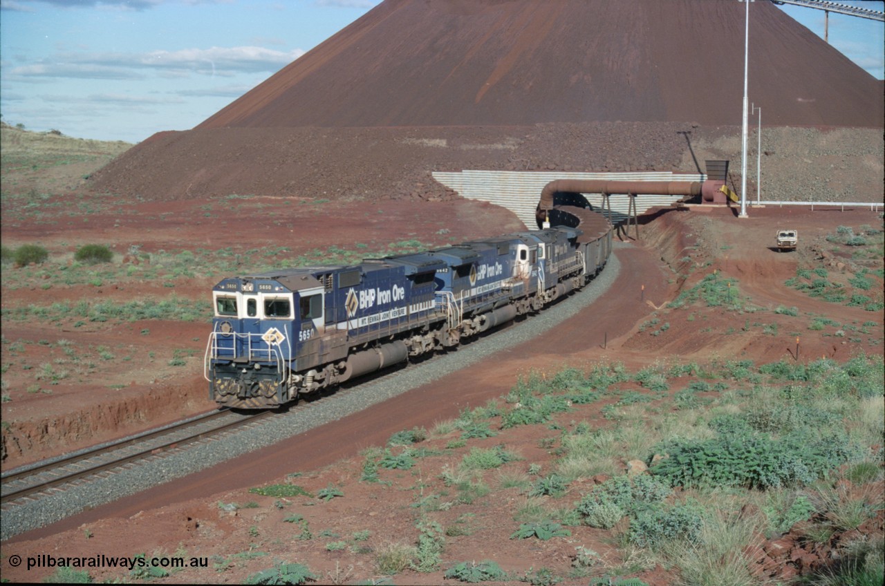 233-25
Yandi Two loaded car side of load-out tunnel, a loading train lead by BHP Iron Ore's Goninan rebuild CM40-8M GE unit 5650 'Yawata' serial 8412-07 / 93-141 as it drags the train through at 1.2 km/h with assistance from two sister units. [url=https://goo.gl/maps/gXRbfYH9U482]GeoData[/url].
Keywords: 5650;Goninan;GE;CM40-8M;8412-07/93-141;rebuild;AE-Goodwin;ALCo;M636C;5481;G6061-2;