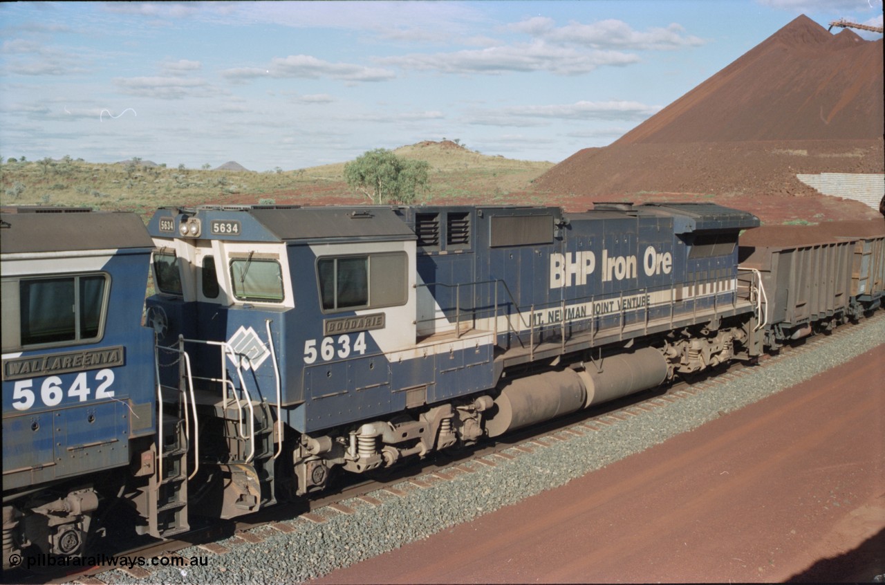 233-32
Yandi Two, BHP Iron Ore's Goninan rebuild CM40-8M GE unit 5634 'Boodarie' serial 8151-07 / 91-120 shows the ALCo heritage from the frame down and is wearing the teal and marigold logo. 5634 was the first CM40-8M rebuild for BHP. [url=https://goo.gl/maps/gXRbfYH9U482]GeoData[/url].
Keywords: 5634;Goninan;GE;CM40-8M;8151-07/91-120;rebuild;AE-Goodwin;ALCo;C636;5457;G6027-1;