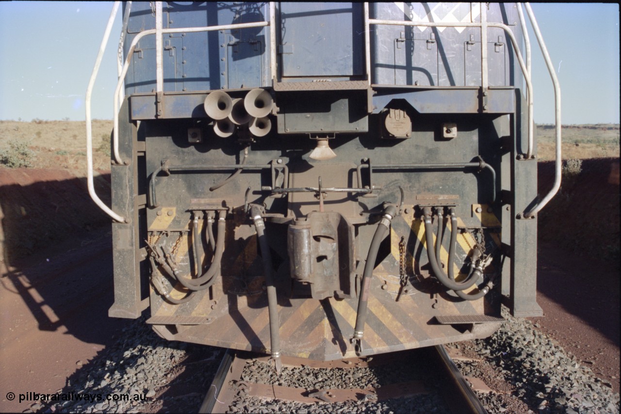 234-03
Yandi Two, BHP Iron Ore Goninan rebuild CM40-8M GE unit 5640 'Ethel Creek' serial 8281-05 / 92-129 is on the rear of a 240 waggon loaded train, this configuration was trialled for a time with two Dash 8 locos, 120 waggons, Dash 8, 120 waggons and Dash 8. View of front pilot. Circa 1998.
Keywords: 5640;Goninan;GE;CM40-8M;8281-05/92-129;rebuild;AE-Goodwin;ALCo;M636C;5479;G6047-11;