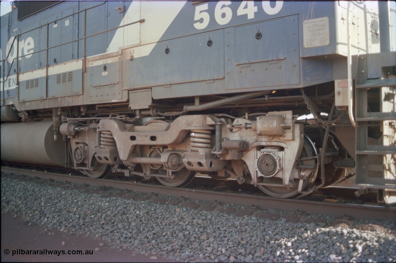 234-15
Yandi Two, BHP Iron Ore Goninan rebuild CM40-8M GE unit 5640 'Ethel Creek' serial 8281-05 / 92-129 is on the rear of a 240 waggon loaded train, this configuration was trialled for a time with two Dash 8 locos, 120 waggons, Dash 8, 120 waggons and Dash 8. View of right hand side leading bogie. Circa 1998.
Keywords: 5640;Goninan;GE;CM40-8M;8281-05/92-129;rebuild;AE-Goodwin;ALCo;M636C;5479;G6047-11;